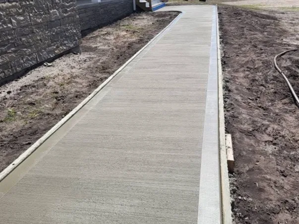 Long finished concrete access walk beside a building
