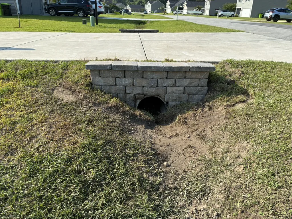 Stone-faced headwall completed around a driveway culvert