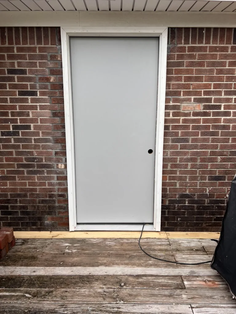 Original single-door opening in a brick wall before widening