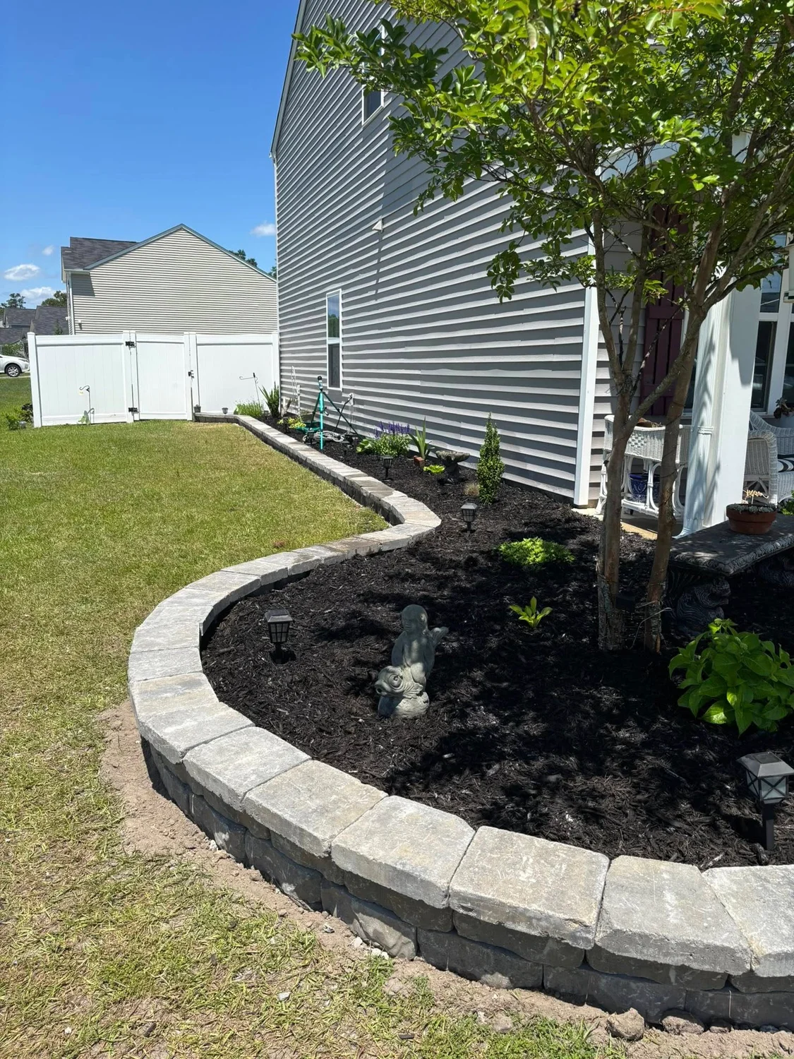 Curved paver border around a landscape bed